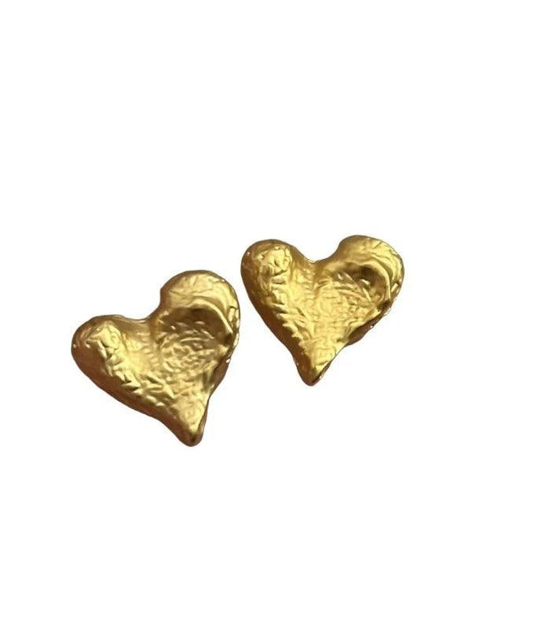 a pair of gold heart-shaped stud earrings with a textured surface. The texture adds a unique, artisanal touch to the classic heart shape.