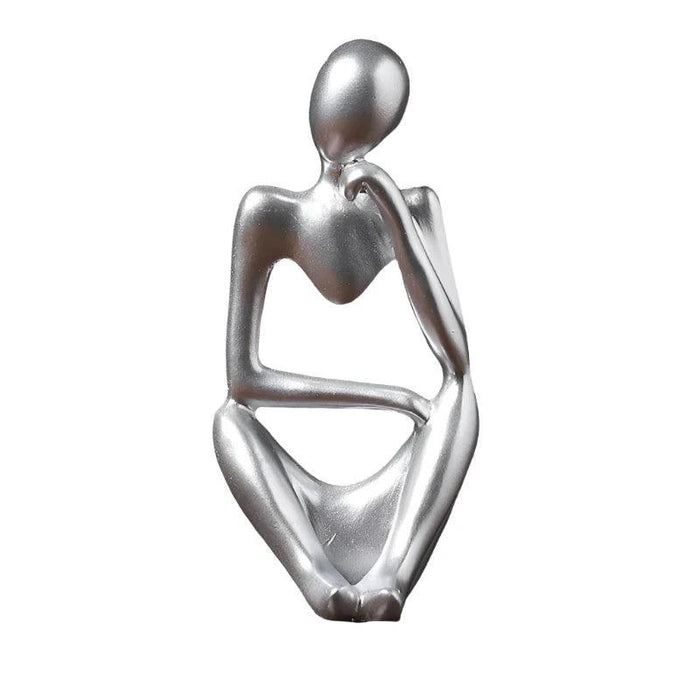 Silver minimalist abstract sculpture of a figure sitting with one hand resting on the chin.