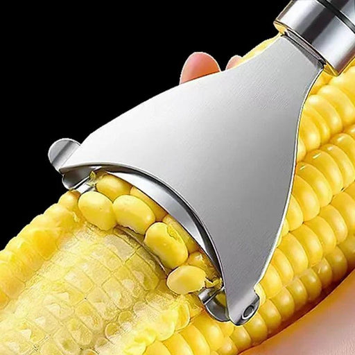 A close-up view of the corn peeler being used to remove kernels from a corn cob. The tool's sharp blade easily glides along the cob, separating the kernels.