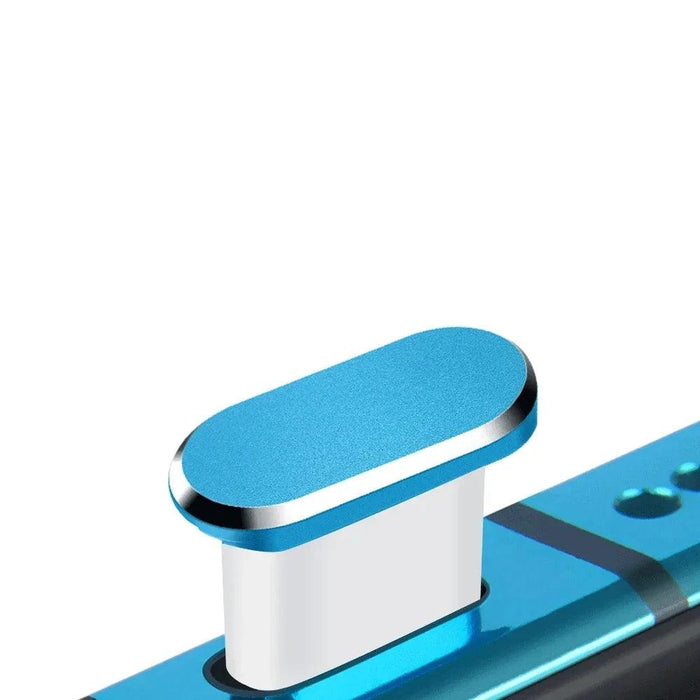 Insertion of a blue magnetic dust plug into a smartphone's charging port.