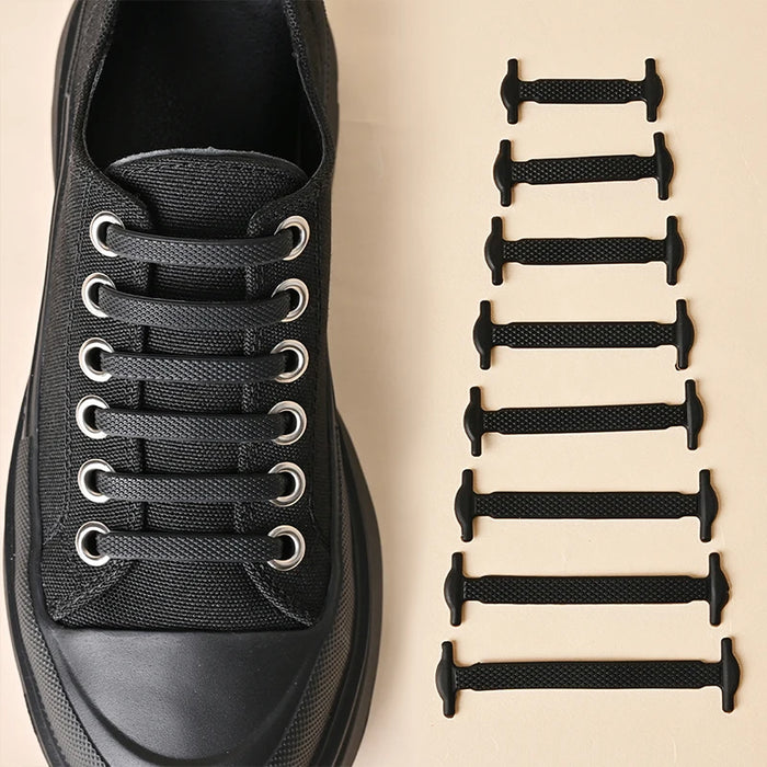 A black shoe shown with the silicone shoelaces attached to it and beside it 8 black shoelaces in different sizes.