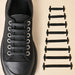 A black shoe shown with the silicone shoelaces attached to it and beside it 8 black shoelaces in different sizes.