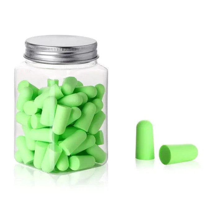 A jar filled with green earplugs. With 2 green earplugs beside it.