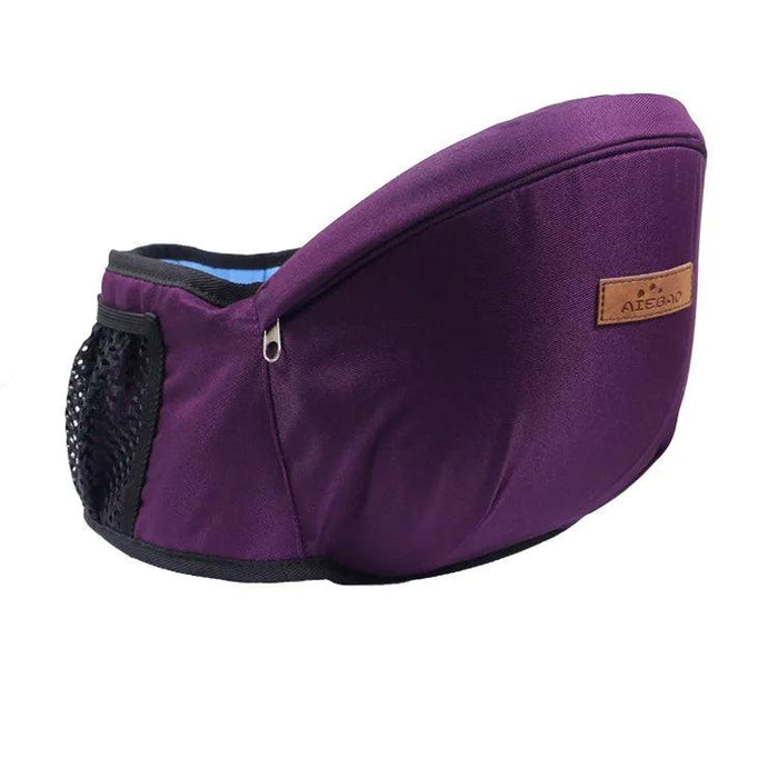 A purple baby waist carrier with a black mesh pocket and brown label tag, perfect for fashionable and comfortable baby carrying.