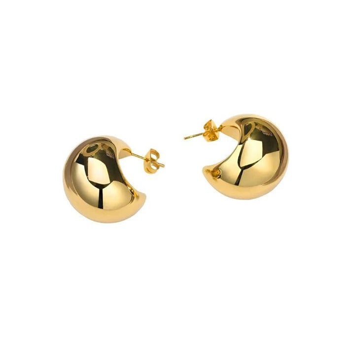 a pair of gold hoop earrings with a thick, chunky design. The earrings are shiny and reflective, placed against a white background for clear visibility.