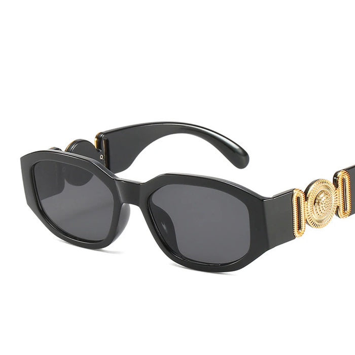 Black sunglasses with gold accents on the arms, showcasing the full frame and design, displayed on a white background.