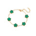 A gold bracelet, designed with a flower-shaped pendant with a green center.