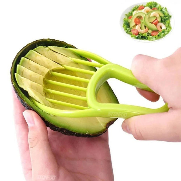 A person using a green avocado slicer to slice an avocado.