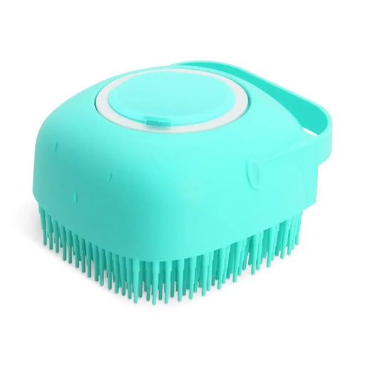  A close-up of the turquoise pet grooming brush, focusing on the bristles and the handle.