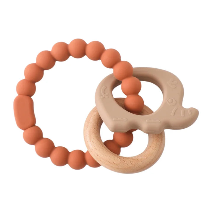 A teething ring set with orange silicone beads, a wooden ring, and a light pink silicone elephant-shaped charm.