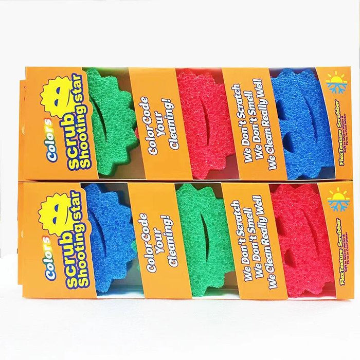 Multiple packages of the "Scrub Shooting Star" sponges are arranged in a stack. The packaging clearly shows the color-coded sponges (green, red, blue) through transparent cutouts, with the product features highlighted on the orange box.