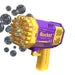 A purple and yellow rocket-shaped bubble gun releasing multiple bubbles. The gun has multiple nozzles and the word "Rocket" printed on the side.