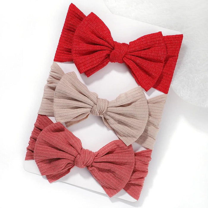 A set of 3 Baby Bow Headbands with different colors.