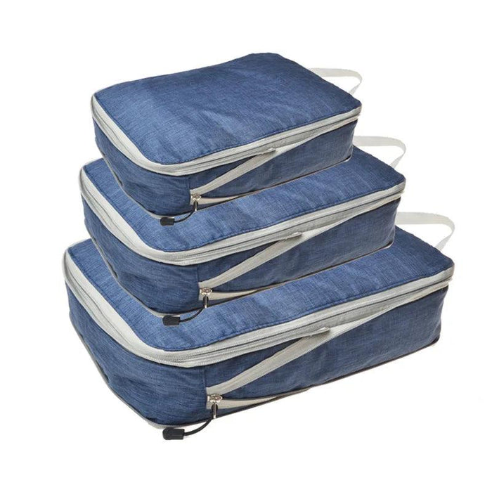 Three dark blue packing cubes with gray zippers and handles, stacked on top of each other. Each cube has a zipper pull with a black tab.