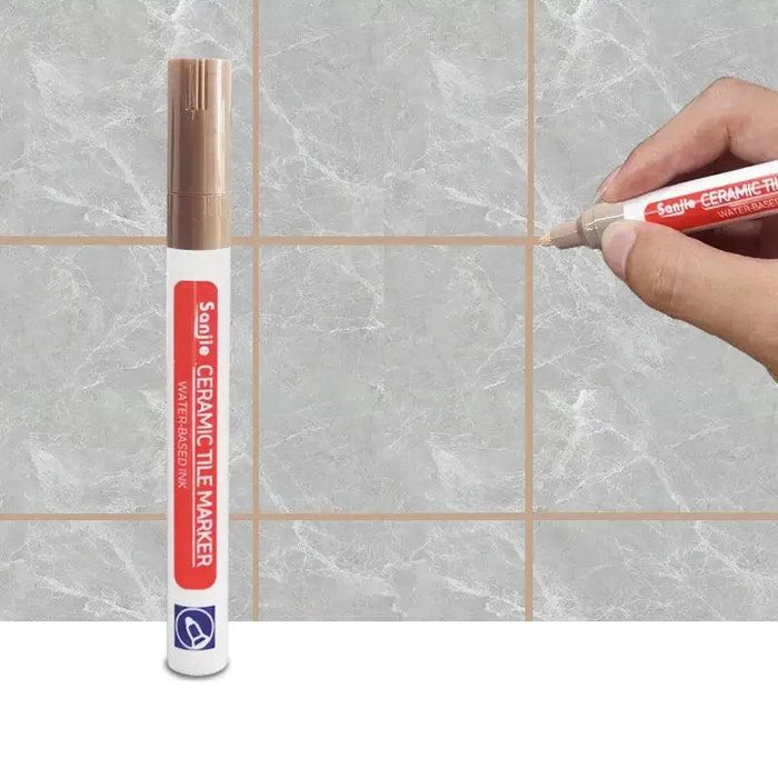 A brown ceramic tile marker in use on a marble-like tile surface, clearly defining grout lines for a polished and clean finish.