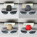 Four leather clips in different colors (black, gray, beige, red), each holding sunglasses and cards.