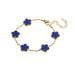 A gold bracelet, designed with a flower-shaped pendant with a blue center.