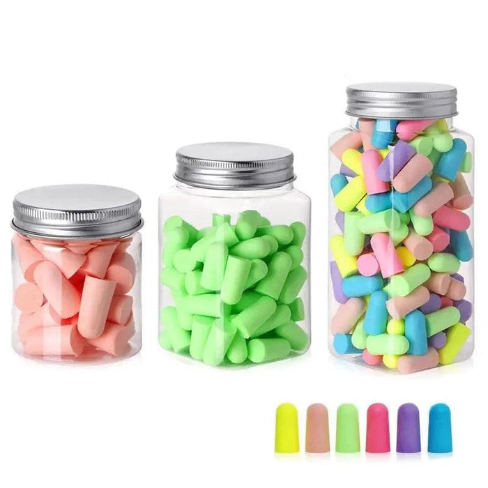 Three jars filled with pastel-colored earplugs in pink, green, and mixed colors.