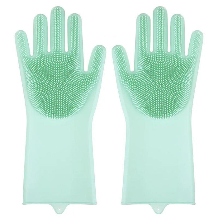 A pair of green silicone cleaning gloves with rubber bristles on the palms and fingers, displayed against a white background.