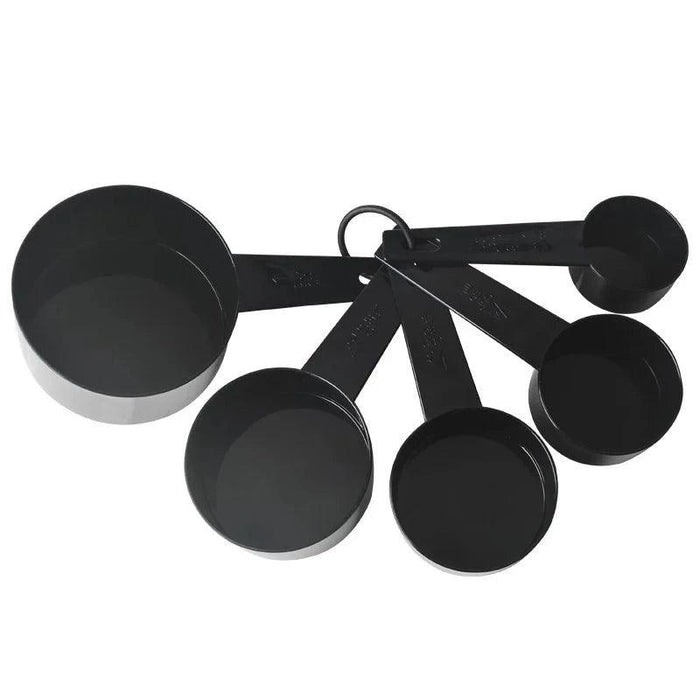 a set of five black measuring cups, fanned out and attached by a ring. The cups range in size and have clearly marked measurements on their handles. The cups appear to be made of a glossy, durable material.