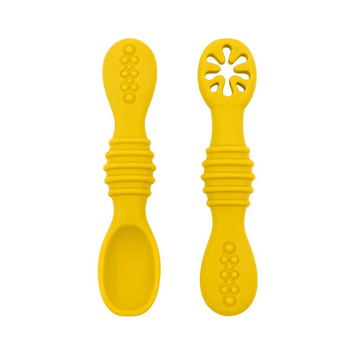 A close-up of two yellow baby spoons, one with a regular spoon shape and the other with a cut-out flower design, against a white background.