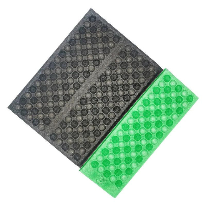 Black and fruit green Foldable Foam Mats: Two foldable foam mats, one in black and the other in blue, placed side by side, both featuring a textured surface with a pattern of raised dots for cushioning and support.