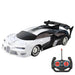 A shiny black and white sports car with black accents and an accompanying remote control. The car features a sleek, aerodynamic design and large rear spoiler.