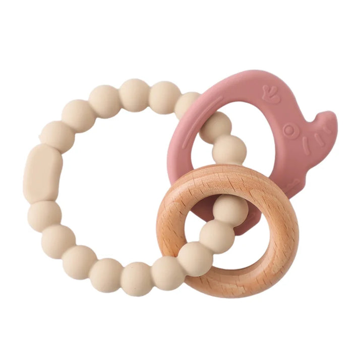 A teething ring set with cream silicone beads, a wooden ring, and a pink silicone elephant-shaped charm.