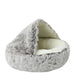 An empty light grey fluffy pet bed with a dome-shaped opening, emphasizing its cozy and plush design