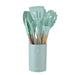 Mint green kitchen utensil set with wooden handles in a matching holder.