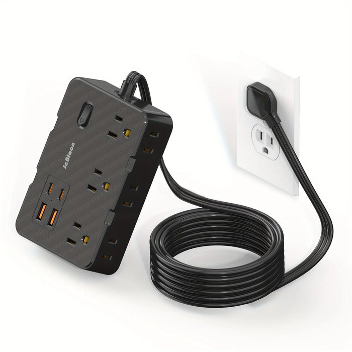 Black power strip plugged into a wall socket, with a coiled black cable.