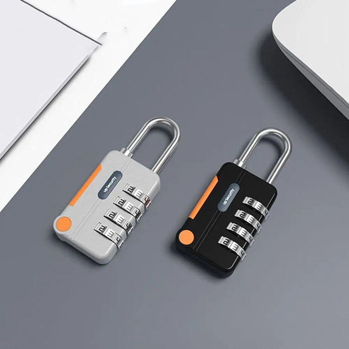 Two combination padlocks, one silver and one black, lying on a grey surface with orange accents and four dials each set to "2-3-4".