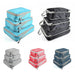 Multiple sets of packing cubes in different colors (light blue, black, gray, red, and dark blue). Each set includes three cubes of varying sizes stacked on top of each other.