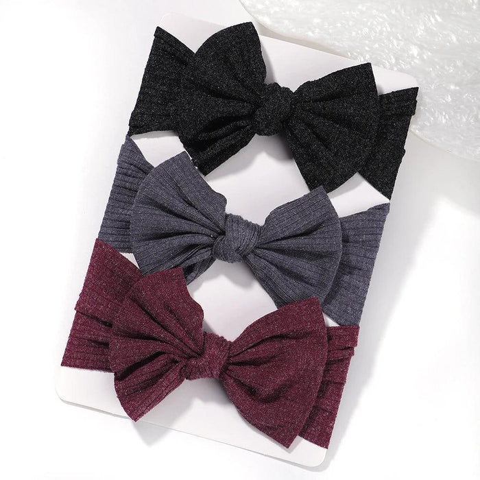 A set of 3 Baby Bow Headbands with different colors.