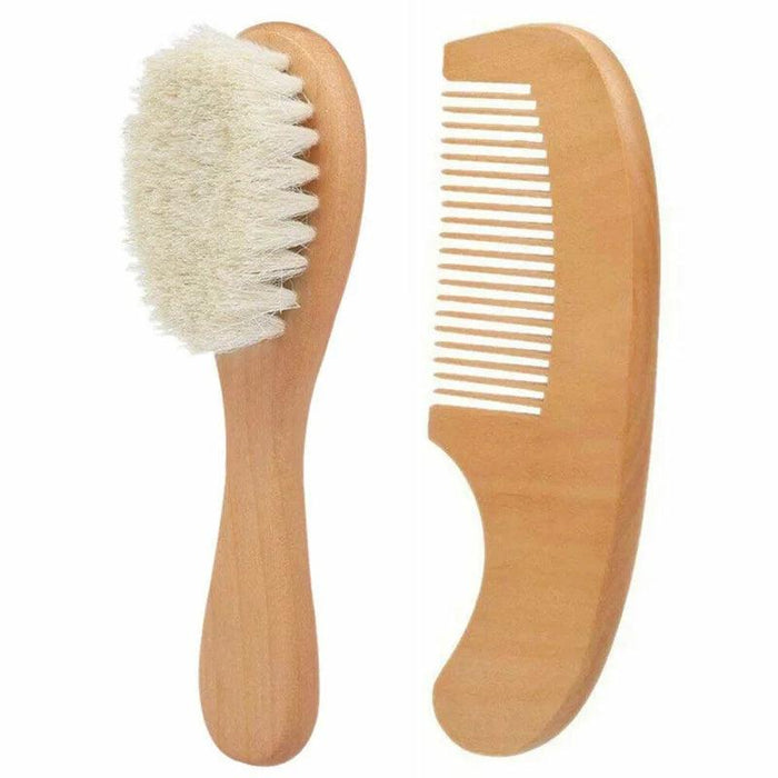 A wooden baby hairbrush with soft bristles next to a wooden comb.