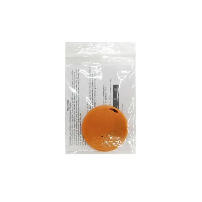 A orange GPS tracker displayed in a sealed plastic bag with instructions visible behind it.