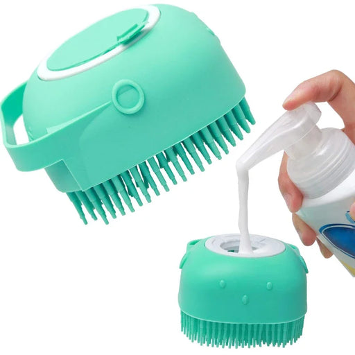 A turquoise pet grooming brush being filled with liquid soap. One hand is holding the brush, and another hand is pouring soap into the top opening.