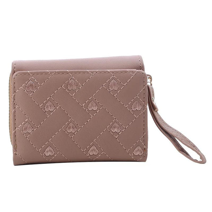 Closed khaki wallet with a quilted pattern, showing the front view with a wrist strap and zipper.