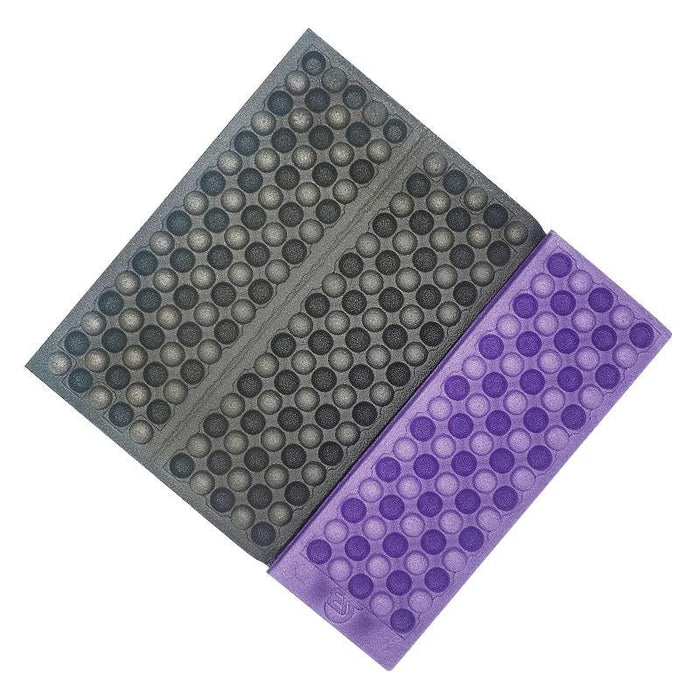 Black and purple Foldable Foam Mats: Two foldable foam mats, one in black and the other in blue, placed side by side, both featuring a textured surface with a pattern of raised dots for cushioning and support.