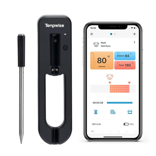 A wireless smart meat thermometer displayed alongside its docking station and a smartphone showing the associated app, which indicates the internal and ambient temperatures for cooking pork.