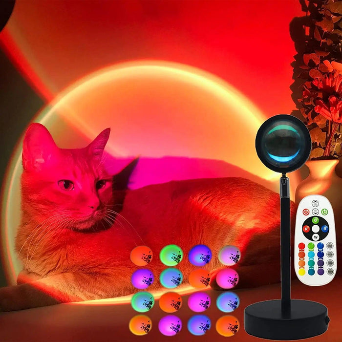 The lamp is shown projecting a warm, red light onto a cat sitting beside it. The photo also includes a remote control and various color options, demonstrating the lamp's ability to create different lighting moods.