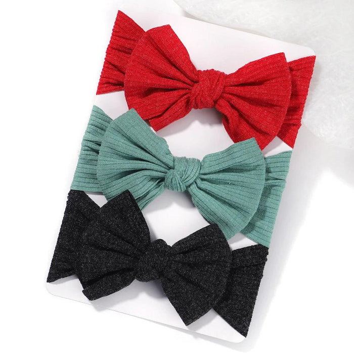 A set of 3 Baby Bow Headbands with different colors.