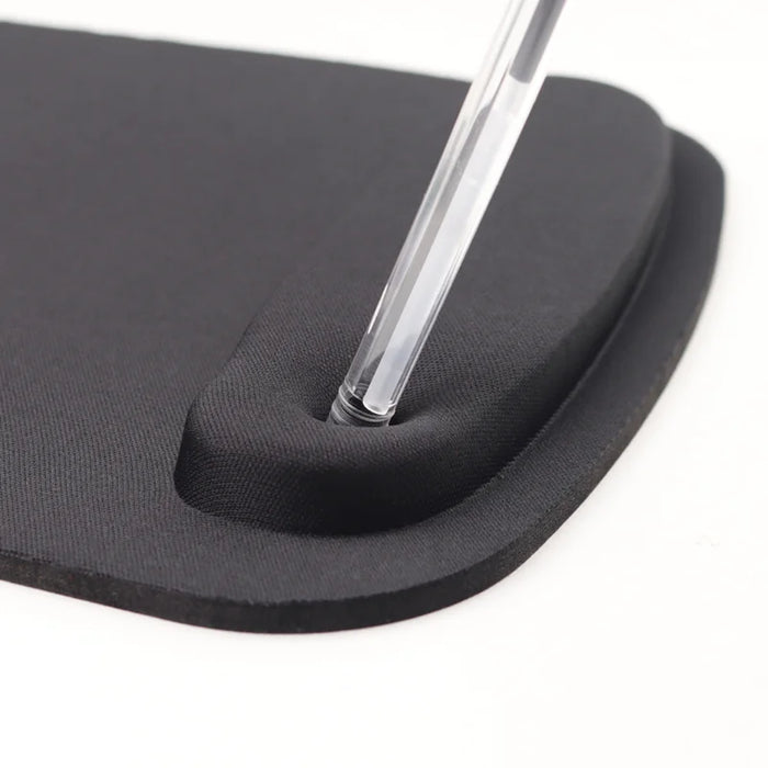 Close-up of a black ergonomic mouse pad with a pen resting on the wrist rest, displayed on a white background.