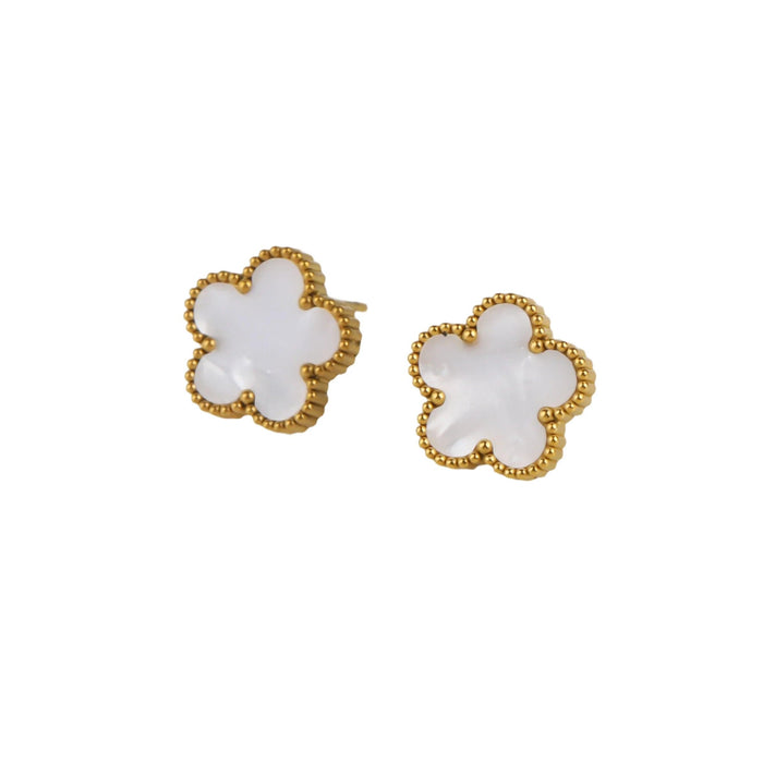 A gold earrings, designed with a flower-shaped pendant with a white center.