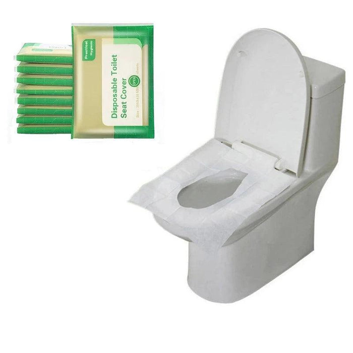 A stack of green and beige packaged disposable toilet seat covers alongside a white toilet, with one cover applied to show the product's practical and hygienic benefits.