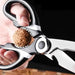 Close-up of multi-purpose kitchen scissors being used as a nutcracker on a walnut.