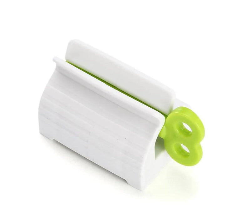 white toothpaste squeezer with a green key.