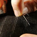 Hand-sewing needles, perfect for detailed work, stored in a compact wooden case.