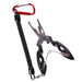 A pair of black fishing pliers with a coiled lanyard attached to a red carabiner, designed for easy access and securing the tool.