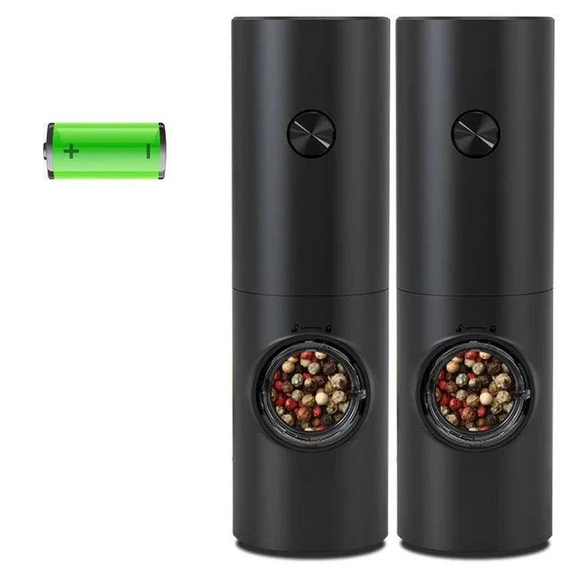 Two black electric grinders with a rechargeable battery, both filled with peppercorns.